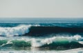 Dark waves with green and blue colours in sunny weather during the storm