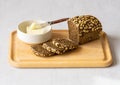 Dark whole grain bread and butter on cutting board. Healthy breakfast. Royalty Free Stock Photo