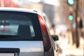 Dark window of gray car parked on the street in summer sunny day, rear view. Royalty Free Stock Photo