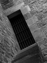Stone prison window with metal bars and wall Royalty Free Stock Photo