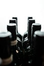 Dark wine bottles stand in a row in backlight. Royalty Free Stock Photo