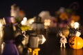 Dark wizard cat using camera to take girl photo with pumpkins and ghost in front of Halloween festival party house. Festive Celebr