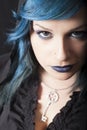 Dark woman with blue hair and lipstick. Key pendant. Dark girl