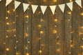 Dark wood background with lights and flags, abstract holiday backdrop, copy space for text Royalty Free Stock Photo