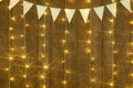 Dark wood background with lights and flags, abstract holiday backdrop, copy space for text Royalty Free Stock Photo