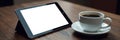 Dark wood table, tablet showing blank screen, coffee in white mug , technology, cozy, tablet Royalty Free Stock Photo