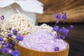 On a dark wooden background, purple bath salt, for relaxation, in a jar, with flowers for fragrance, close-up Royalty Free Stock Photo