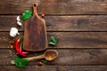 Dark wooden culinary background with various herbs and spices, top view, rustic