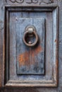 Dark wooden door panel with door knocker. Royalty Free Stock Photo