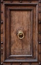 Dark wooden door panel with door knocker. Royalty Free Stock Photo