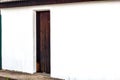 Dark wooden door in white wall Royalty Free Stock Photo