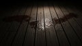 Dark wooden floor with spilled liquid and dramatic spotlight illumination Royalty Free Stock Photo