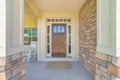 Dark wooden front door with transom window and side panels Royalty Free Stock Photo