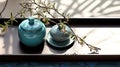 Dark wooden serving tray ceramic turquoise blue vase and jar and antique blue Chinese book with space on white fabric tablecloth