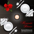 Dark wooden table served for a couple with a burning candle, two plates, knives, forks, spoons, napkins and a bunch of roses. Roma Royalty Free Stock Photo