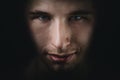 Dark young adult man portrait fade in black Royalty Free Stock Photo