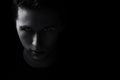 Dark young adult man portrait fade in black Royalty Free Stock Photo