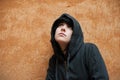 Dark young woman sad standing near urban wall portrait