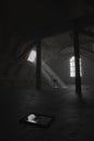 darken empty attic with aged stuff and mystic light through windows Royalty Free Stock Photo