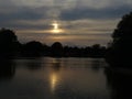 Darkened sunset over a lake with atmophere Royalty Free Stock Photo