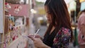 A darkhaired woman writes her order on a piece of paper