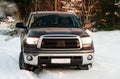 Darkly Gray sport utility vehicle in winter forest