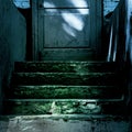 Darkness and horror at the closed entrance door to the ghost house. Dark stone ruined old staircase from the basement with Royalty Free Stock Photo