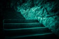 Darkness and horror, ghost house. Dark stone ruined old staircase from the basement with mystical shadows and strange light Royalty Free Stock Photo