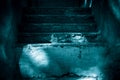 Darkness and horror, ghost house. Dark stone ruined old staircase from the basement with mystical shadows and strange light Royalty Free Stock Photo