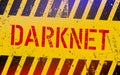 Darknet on warning sign. Grungy style. Cyber crime concept. Dark side of internet