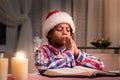 Darkskinned boy praying on Christmas.
