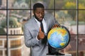 Darkskinned man with globe.