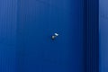Darl blue building wall and white security camera on it.Blank surface Royalty Free Stock Photo