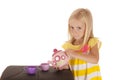 Darling young blond girl playing with a tea set Royalty Free Stock Photo