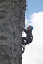 Child climbing on a climbing wall for fun activity