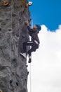 Child climbing on a climbing wall for fun activity