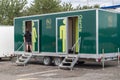 Child entering public toilets restroom outdoor on a trailer