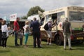 Customers queuing and buying ice cream from ice cream van at a festival