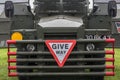 Give Way warning road traffic sugn symbol on the front of a vintage military vehicle truck