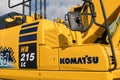 Large yellow Komatsu industrial digger machine showing company name, logo and branding