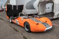 Orange retro classic racing car with engine cover up