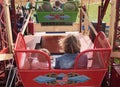 People in seats on ferris wheel fun fair carnival ride Royalty Free Stock Photo