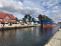 Darlowko, Poland: Cargo ship leaving the port on a summer day