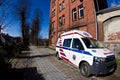 Darlowo, Poland -emergency ambulance parked at multifamily brick house