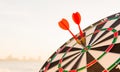 Dart arrow hit center on bullseye dartboard is target