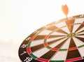 Dart arrow hit center on bullseye dartboard is target