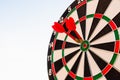 Dart arrow hit center on bullseye dartboard is target