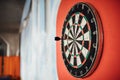 Dart arrow hitting in bulls eye on dartboard.Success hitting target aim goal achievement concept.Indoor game,played at home. Royalty Free Stock Photo