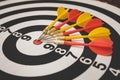 dart arrow hitting in target center of dartboard,abstract of success