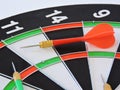 Dart arrow hitting in the target center of dartboard. Success hitting target aim goal achievement concept background.Darts and dar Royalty Free Stock Photo